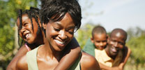children riding piggy-back on parents