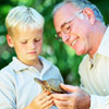 senior showing a turtle to a boy